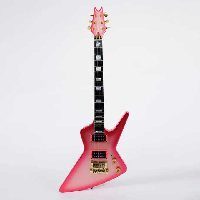 The electric guitar in hot pink finish with mother-of-pearl inlay on fingerboard.