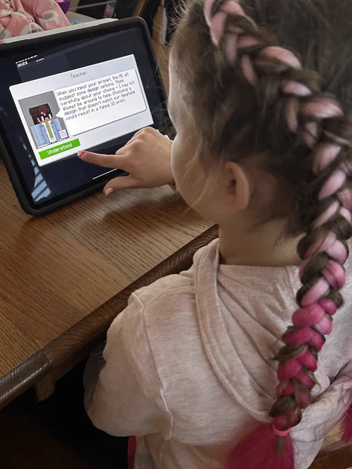 Girl on iPad with Minecraft Education CyberSafe AI: Dig Deeper on screen