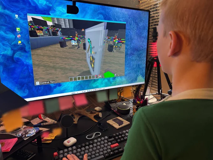 Boy at computer screen with Minecraft Education CyberSafe AI: Dig Deeper on the screen