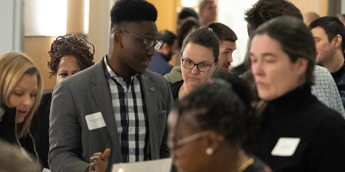 Medical students mingle with members of community-based organizations at the Community Table event at the Jacobs School.