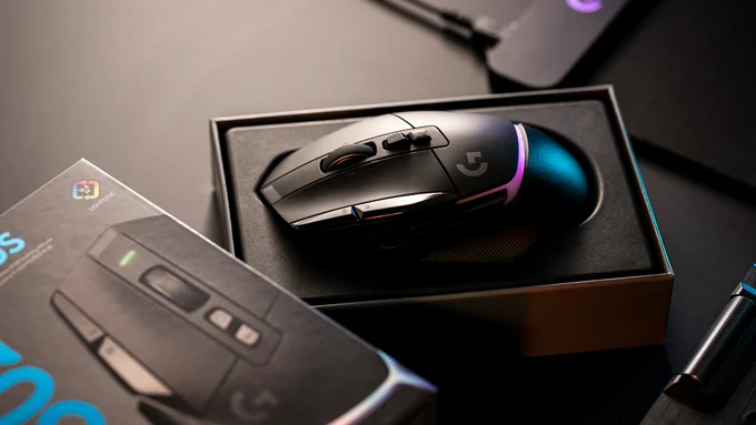 A black Logitech G502 X PLUS resting in its box.