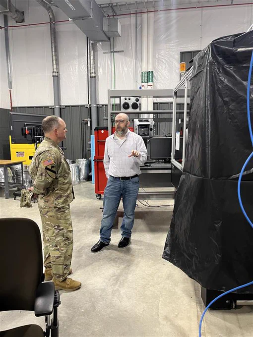 Two men standing in the Ballistic, Aero-optics and Materials range at Texas A&M-RELLIS.