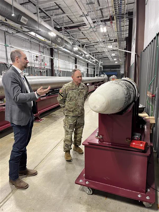 Two men standing in the Ballistic, Aero-optics and Materials range at Texas A&M-RELLIS.