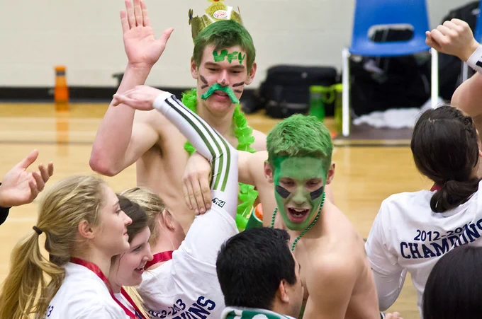 The men’s team going green to support the women’s volleyball team in 2013.