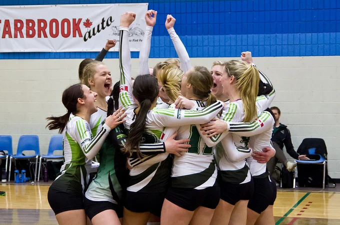 Cascade volleyball women celebrating a championship victory in 2013.
