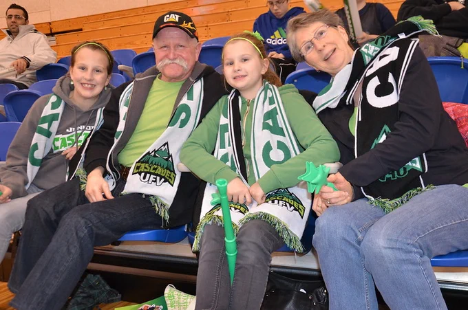 Deanna (left) and Julia (second from right) Tuchscherer watch a UFV playoff game against Saskatchewan with their grandparents in February 2013. 