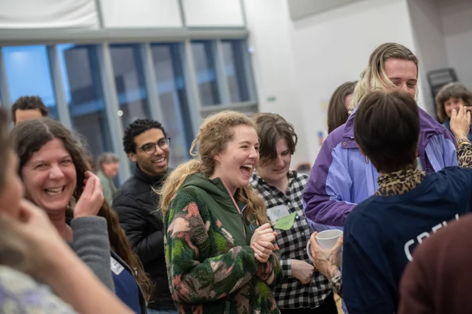 Participants laugh in an ice breaking game.