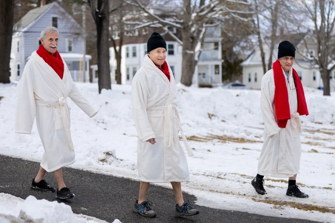 Lars Llorente '78, Chris Callahan ’78, and Scott Copeland ’78, walk along a path as they head to Bates' Lake Andrews for the annual "Puddle Jump" a tradition the three started in 1975.