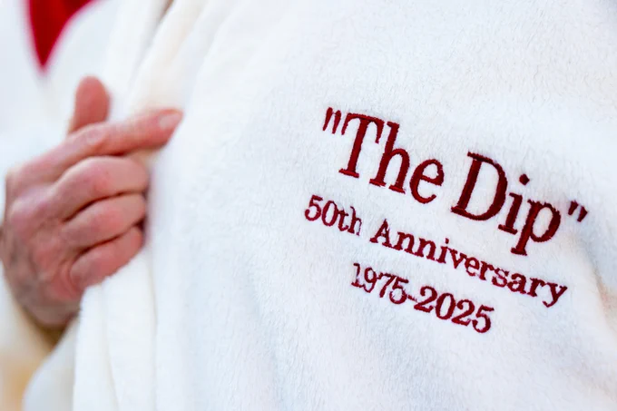 Close up shot of robe to see lettering saying the following, "The Dip" 50th Anniversary, 1975-2025
