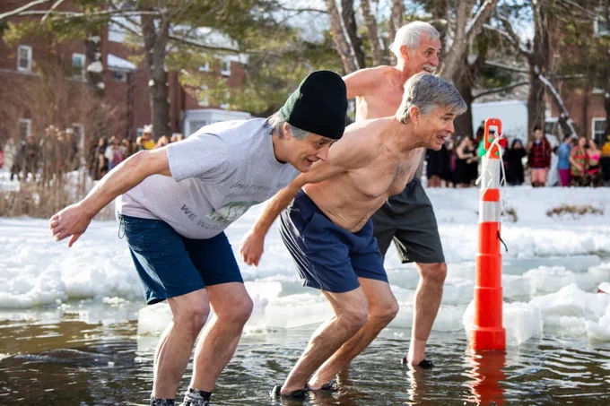 Lars Llorente '78, Chris Callahan ’78, and Scott Copeland ’78 begin their jump into the icy waters of Bates' Lake Andrews (a.k.a. "The Puddle")
