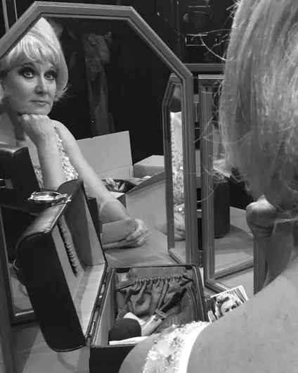 Actor playing Dusty Springfield looking in the dressing theatre mirror