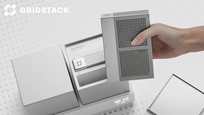 A sleek, modular NAS (network-attached storage) system with a minimalist silver design. A person’s hand is lifting a perforated storage module, revealing a high-tech dual HDD block inside. The system features a digital LED display and a clean, grid-patterned background. The Gridstack logo is visible, reinforcing a premium, design-forward storage solution for creative professionals.