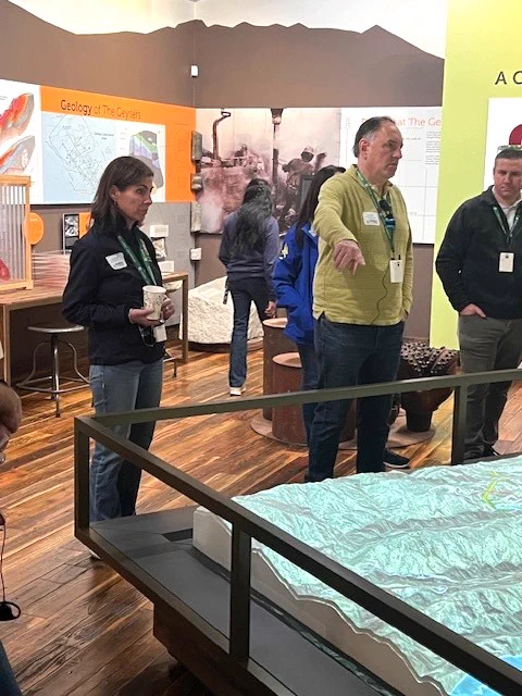 Assemblymember Papan with Calpine staff looking at a model of the Geysers landscape to understand the geological and hydrological dynamics of the area.