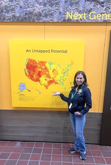 Assemblymember Papan in front of a map of geothermal activity throughout the United States.