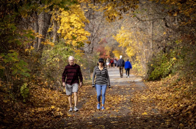 People walking on the Huckleberry Trail in autumn.