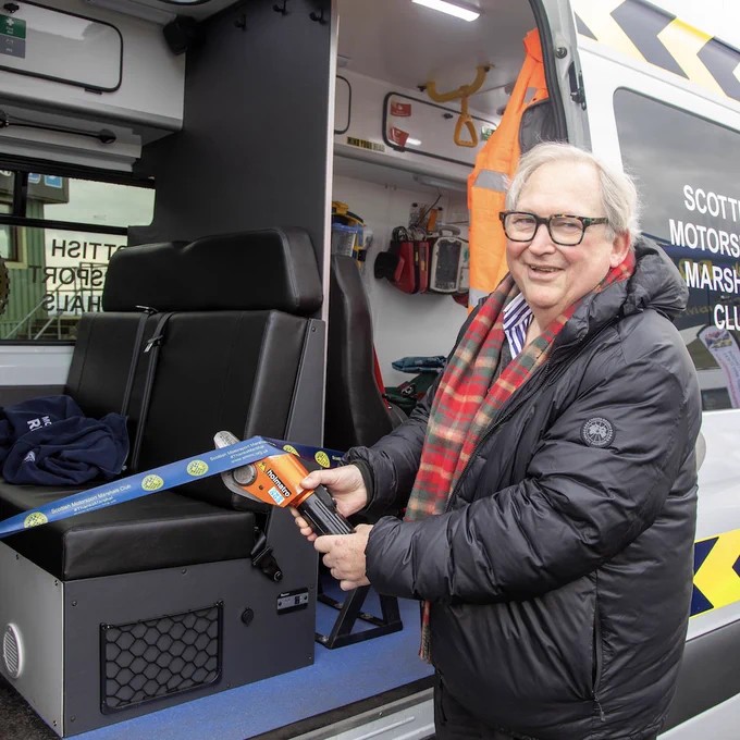 Dr Paul Trafford cutting the ribbon at the launch of SMMC's new Motorsport Rescue Ambulance