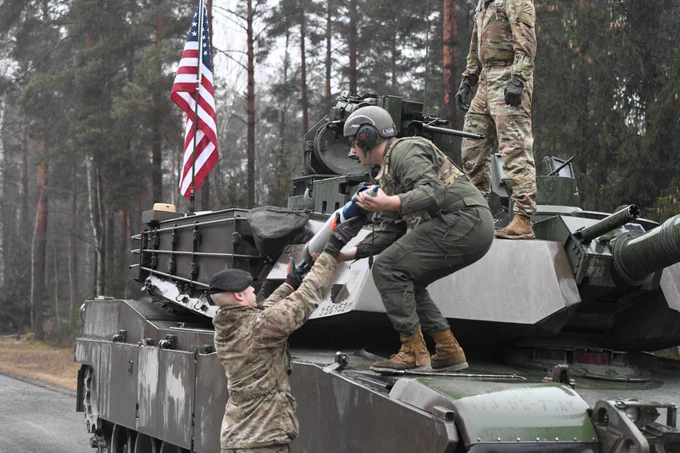 A tanker from the United States grabs ammo from a Denmark soldier as part of the U.S. Army Europe and Africa International Tank Challenge at 7th Army Training Command’s Grafenwoehr Training Area, Germany. The USAREUR- AF International Tank Challenge builds tactical skills and enhances esprit de corps across the 11 teams from five participating allied and partner for peace nations.