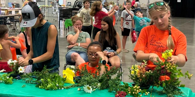 4-H youths prepare floral arrangements at the Linn County Fair.