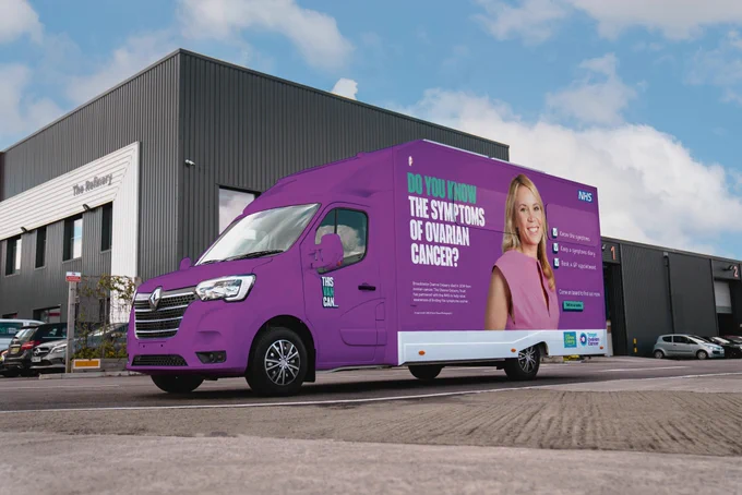 A bright purple van with a photo of the late Dianne Oxberry on the side and the words "Do you know the symptoms of ovarian cancer?"