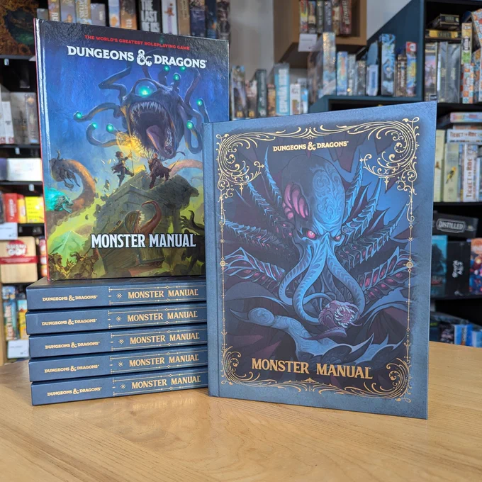 Copies of the new Monster Manual in the Edinburgh board game shop. On the right is a copy of the alt cover and on the left is the regular cover.