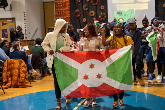Students carry a flag during a Parade of Nations.