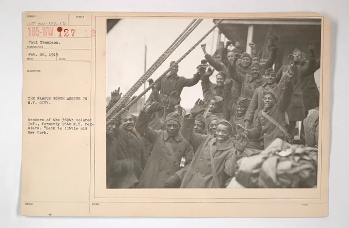 Archival record: Colored Troops - The famous 369th arrive in New York City. Members of the 369th colored infantry, formerly 15th New York regulars. "Back to little old New York."
Photo by Paul Thompson, Feb. 26, 1919