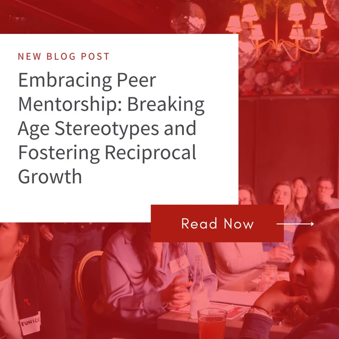A blog post banner. The banner has a reddish-maroon background with a light beige rectangular area displaying the blog post title and subtitle in a clean, sans-serif font. Below the text, a bold, reddish-maroon "Read Now" button serves as a clear call to action. The background features a blurred image of a group of people seated at tables, engaged in discussion. The lighting and colours in the background contrast with the bold tones of the blog post title, adding depth to the design. 