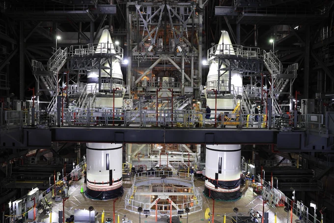 The right and left forward segments and forward assemblies are seen stacked on Mobile Launcher 1, surrounded by High Bay 3 platforms in the Vehicle Assembly Building at NASA's Kennedy Space Center. 