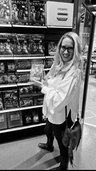Tory holds a copy of Deathworlder at Warhammer World