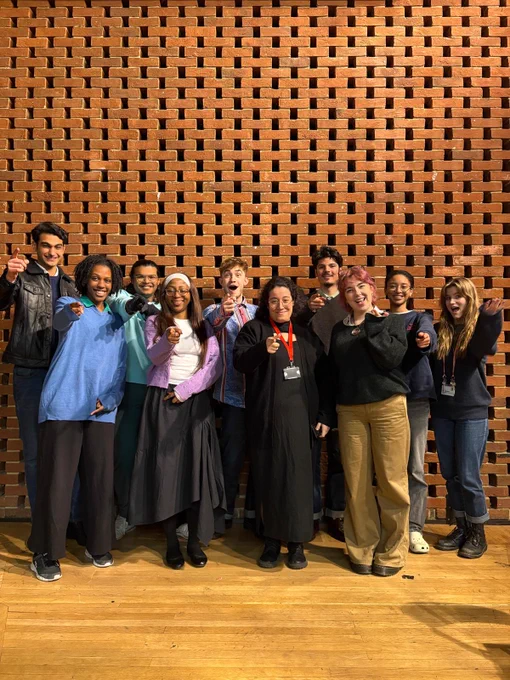 A group of 10 student officers smiling and pointing to the camera