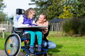 Girl in wheelchair with parent /carer