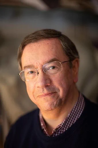 older man with brown hair and glasses 
