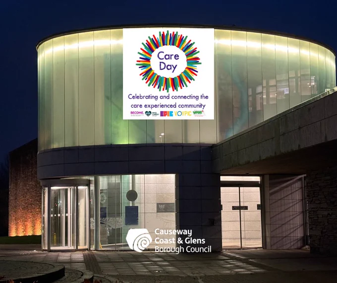 Image of Cloonavin with yellow lights shining, with the Care Day and Causeway Coast and Glens Borough Council logos.

