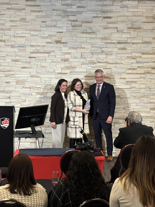 Nancy Arnold and Duane McNair presenting an award to Melanie Dow.
