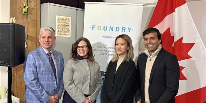 A photo at today's announcement featuring Co-Executive Director of Foundry BC Steve Mathias, Minister of Mental Health and Addictions of Canada Honorable Ya'ra Saks, Foundry Surrey Youth Advisor Evie, and Member of Parliament Taleeb Noormohamed standing in front of a Foundry Banner and Canadian Flag.