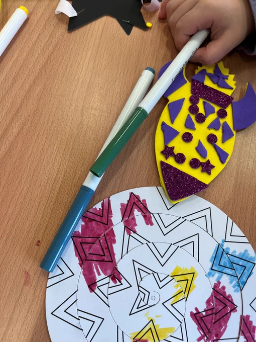 Picture shows a yellow foam rocket and a coiled paper snake.