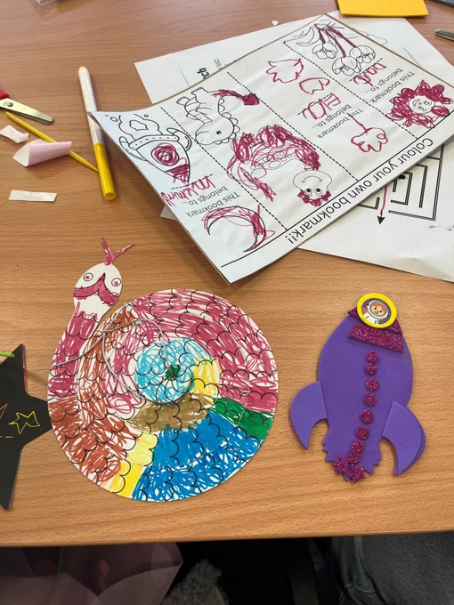 Picture shows a coiled paper snake, some scratch art, a foam rocket and some personalised bookmarks.