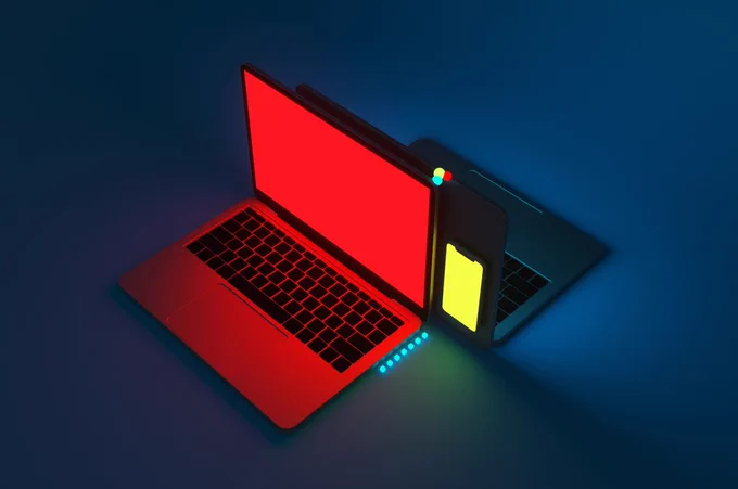 Two laptops back to back, one in red, and one with a hello panel on the back.