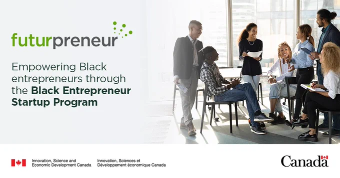 A group of diverse young professionals engage in a discussion in a modern office with large windows. With the text: Empowering Black entrepreneurs through the Black Entrepreneur Startup Program.