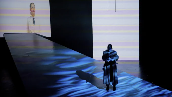 In a scene from Love and Information, a virtual censor (Sarah Baleigh) gives notes to a writer about their novel (Serina Wold).  Photo: Lauren Buscemi