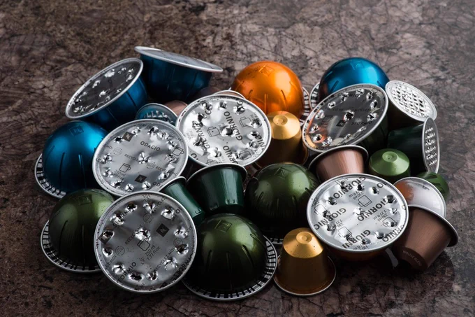 A pile of used coffee pods on a kitchen worktop