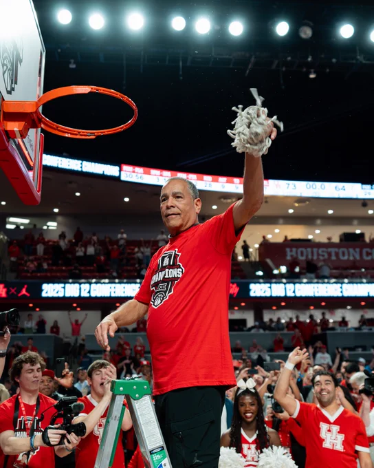 Coach Kelvin Sampson waving the net in the air from the game against Cincy in celebration of being Big 12 champions.