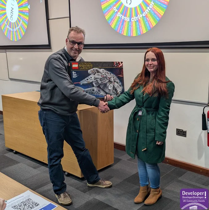 Lex of Turbo360 handing over a Lego Millennium Falcon to the prize winner.