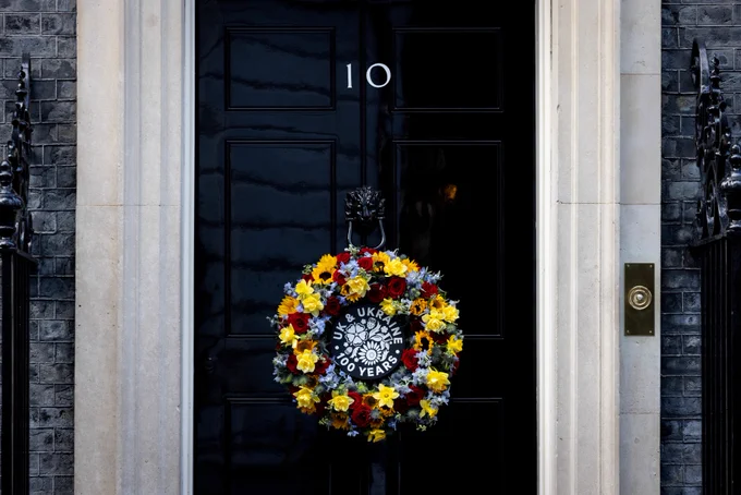 Wreath with the wording 'UK and Ukraine, 100 Years' hanging from the front door of 10 Downing Street on the 24th February 2025.