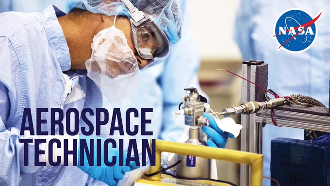 Aerospace technician Craig Tretheway wears goggles and clean room gear while adjusting the valves of a high-pressure tank used to carry oxygen to the International Space Station