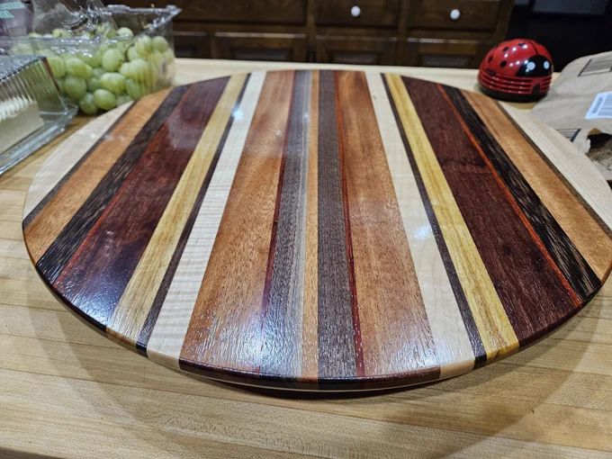 Lazy susan made from varying thick and thin strips of walnut, maple, canary, mahogany, padauk, wenge and curly soft maple.