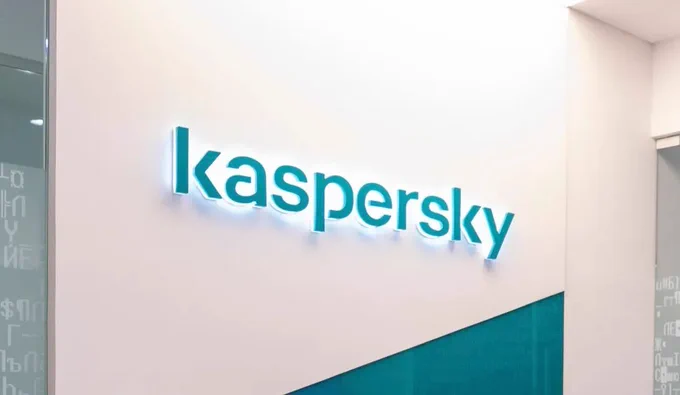 The Kaspersky software logo - the company's name in blue - on a white wall. 