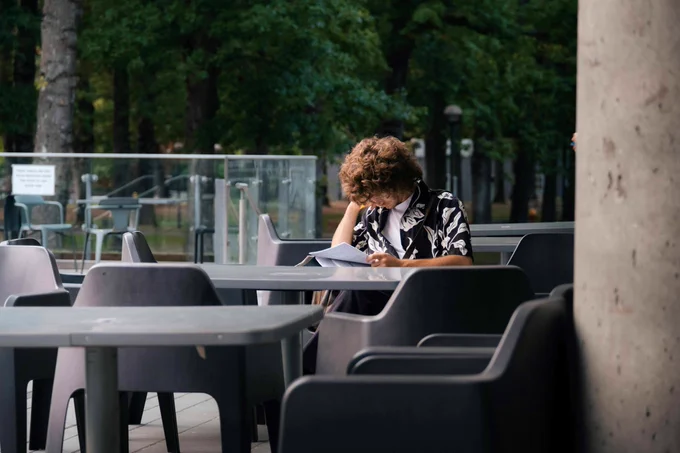 A person sitting at a table and writing.