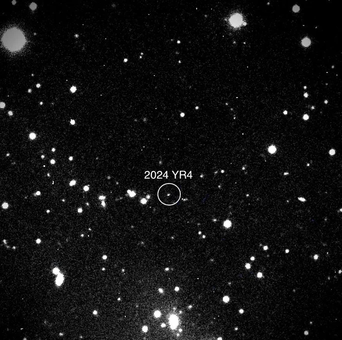 A black-and-white image of asteroid 2024 YR4, a small dot in the center of a swarm of larger ones. The asteroid is circled, with "2024 YR4" in text above it. Credit: NASA/Magdalena Ridge 2.4m telescope/New Mexico Institute of Technology/Ryan