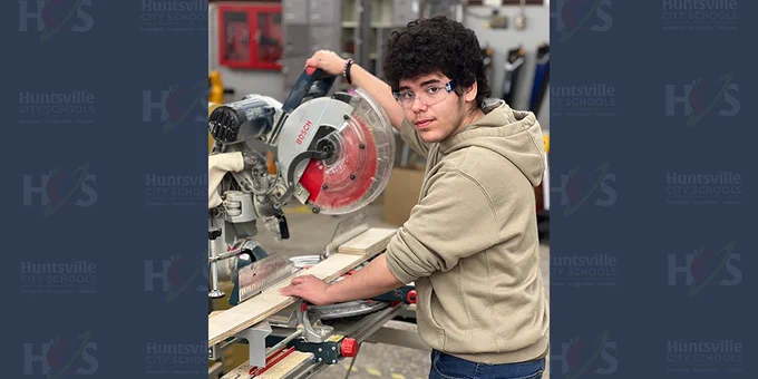 Aiden Hensley working at a miter saw